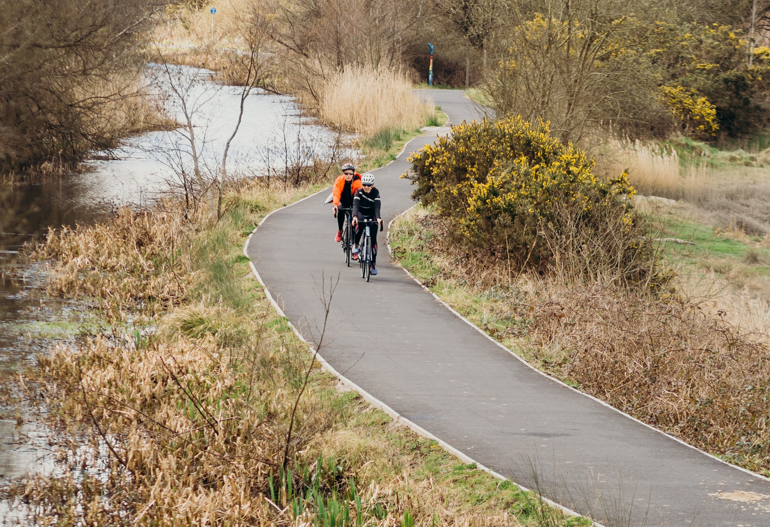 Two people on a cycle track