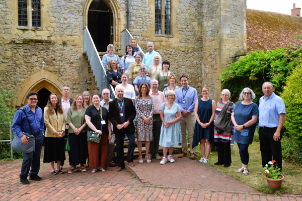 A group of people standing outside an old building, after finishing a networking event on culture and heritage.