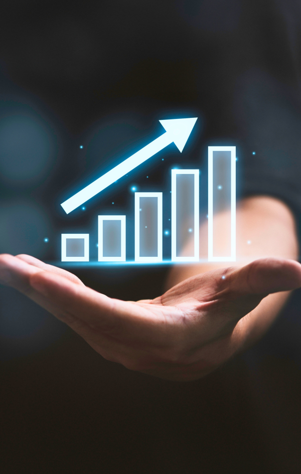 Hand holding a glowing 3D bar chart with an upward arrow, symbolizing business growth or financial success.