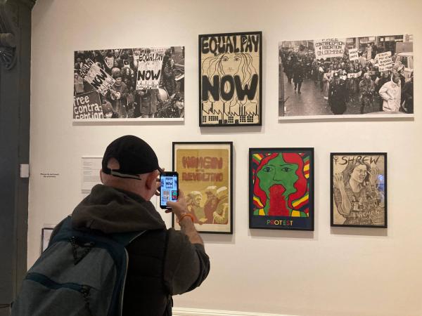 Alan taking a photograph of artwork in the 'Women In Revolt' exhibition.