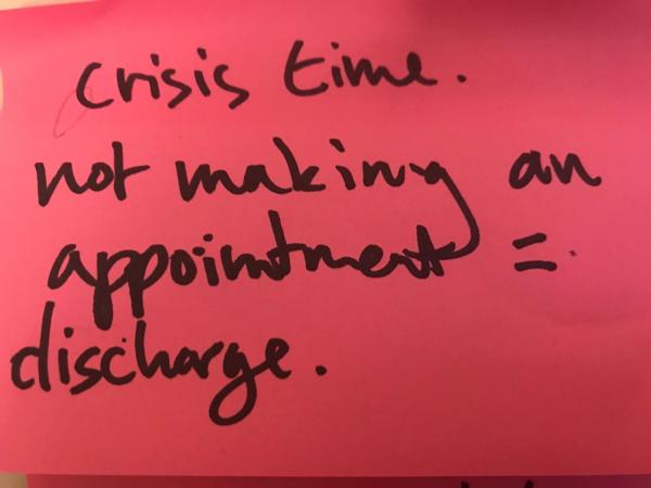 A post it note with the words 'crisis time not making an appointment = discharge