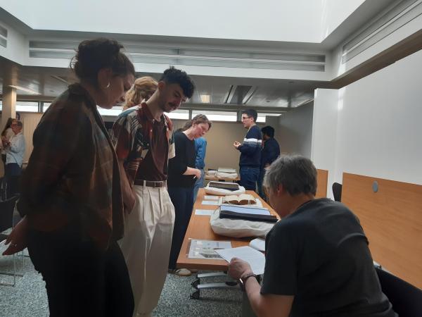 A group of people discussing and looking at materials in the Lothian Health Services Archive