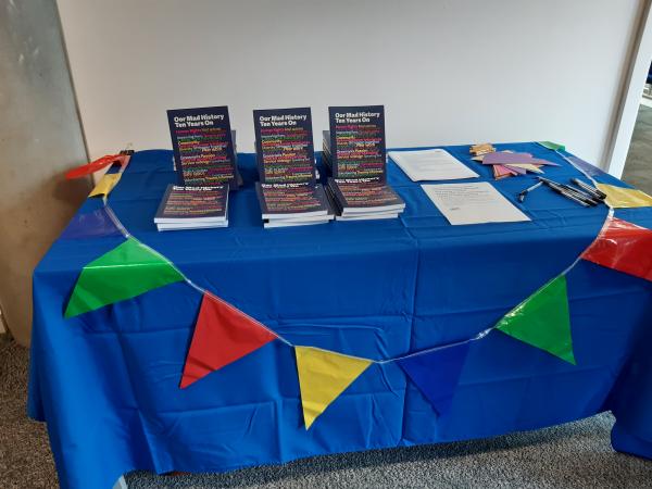 A table with Oor Mad History books and bunting