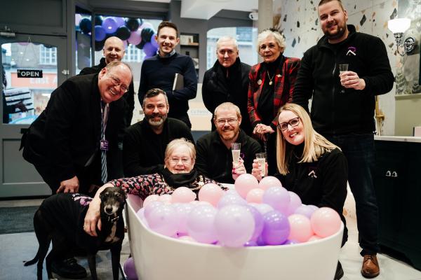 Group of smiling councillors and team members at Rai and Rai Bathrooms opening event