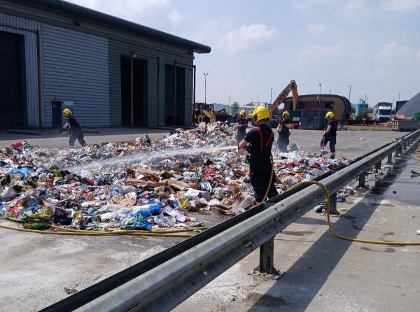 Firefighters douse tipped refuse