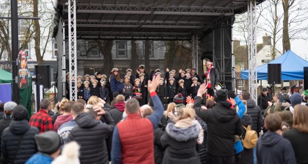 Crowds watch children on stage at March Christmas Market 2025