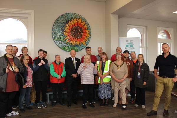 Students and staff from FACET join Hereward Community Rail Partnership representatives, Greater Anglia representatives and the Chairman of Fenland District Council, Cllr Brenda Barber, at the official unveiling of the FACET sunflower mosaic at March Station.