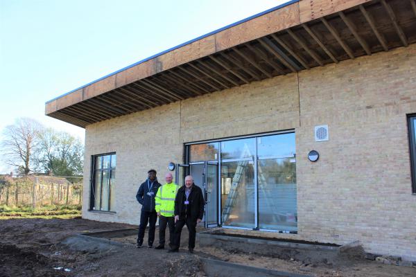 Pictured outside the progressing Wisbech Park community pavilion are, from left, Cllr Sidney Imafidon, town and district councillor for Wisbech; Terry Jordan, clerk of Wisbech Town Council; and Cllr Peter Murphy, Fenland District Council's Portfolio Holder for Environment.