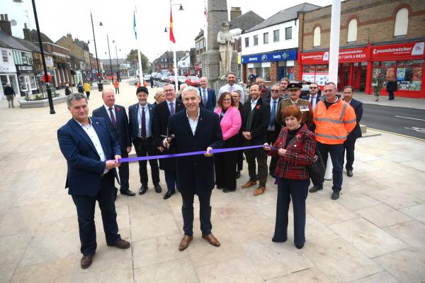 Image above: MP Steve Barclay, centre, cuts the ribbon with Cllr Jan French, right, and Jamie Harrison, of Octavius, left, with, in the background, project partners and armed forces representatives, who raised the flags. 