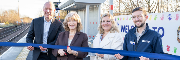 A photo of four people including Councillor Denise Jeffery cutting a ribbon on a train station platform