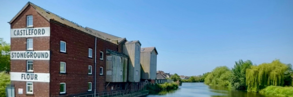 A photo of Queen's Mill in Castleford, stood next to the River Aire
