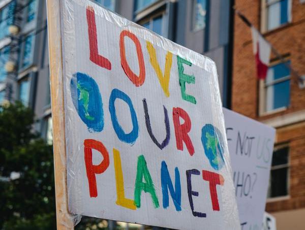 hand painted sign that reads love our planet