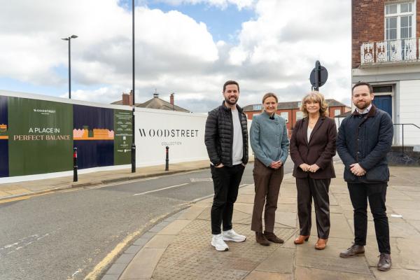 A photo of Councillor Michael Graham, Councillor Denise Jeffery and two representatives from Rushbond next to the site of the Wood Street Collection