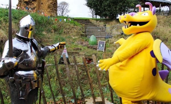 Ilbert the Dragon and a knight pointing towards a large green egg at Pontefract Castle