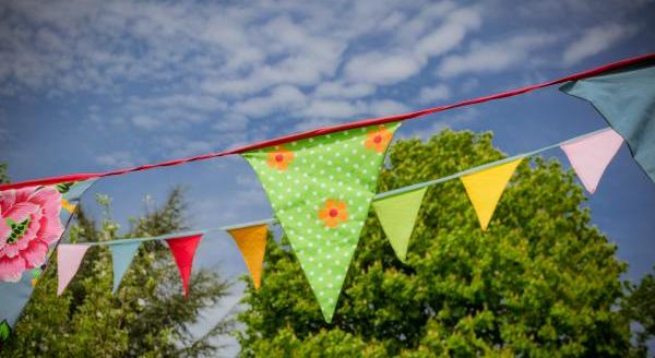 Bunting with bright floral patterns hung outside on a sunny day