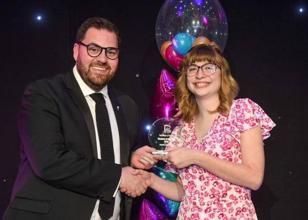 Sophie receiving her REACH Award from Ken Merry