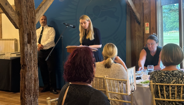 Deputy Commissioner Ellie Vesey-Thompson speaking behind microphone stand at the tackling anti-social behaviour awards in Surrey in September