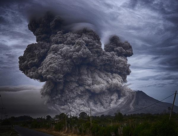 volcano with thick grey smoke plume