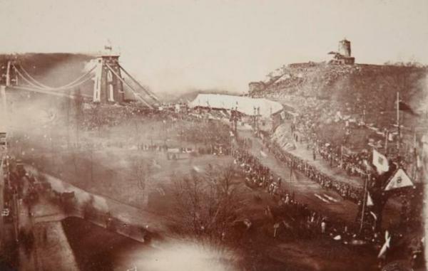 sepia photograph of the opening of Clifton Suspension Bridge. Crowds gather