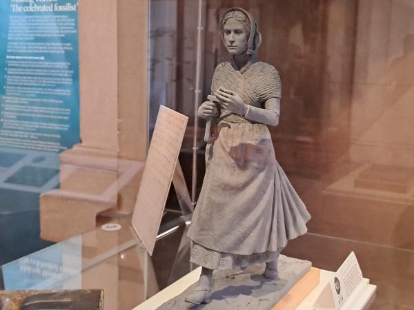 clay maquette of palaeontologist Mary Anning in a display case at museum