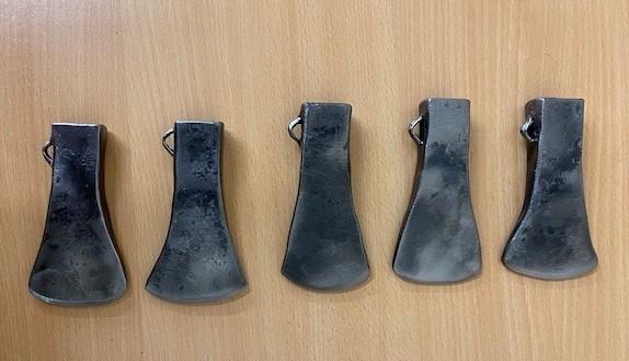 a row of replica Bronze age axe heads