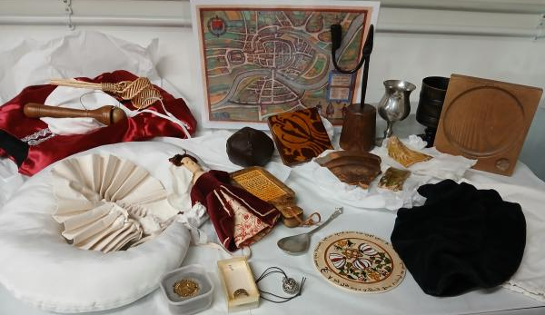 replica and real objects from a Tudor home laid out on a white table cloth