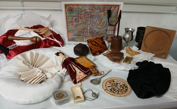 replica and real objects from a Tudor home laid out on a white table cloth