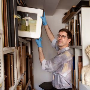 A man holding a painting