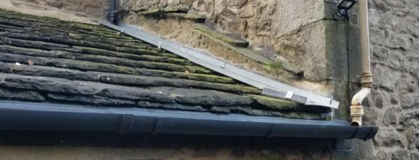 A slate roof with new guttering
