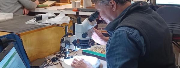A man looking through a microscope
