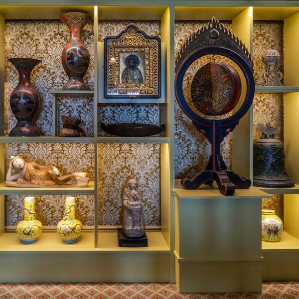 A collection of East Asian vases on shelves