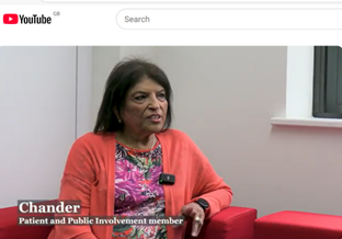 A person in a pink jacket is in conversation