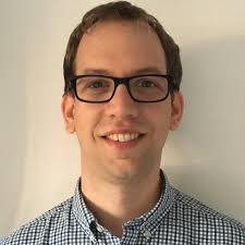 A profile picture of a person facing the camera. They're smiling and wearing glasses.