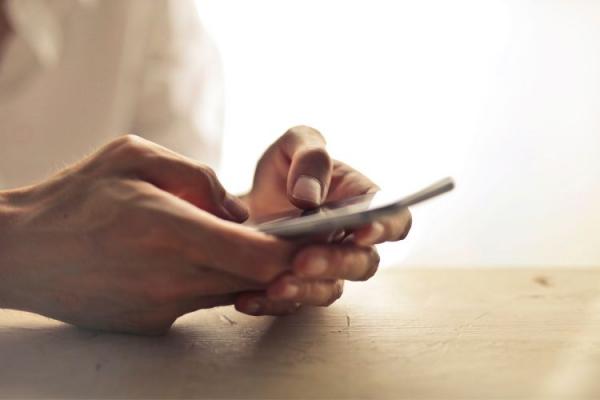 Two hands holding a mobile phone