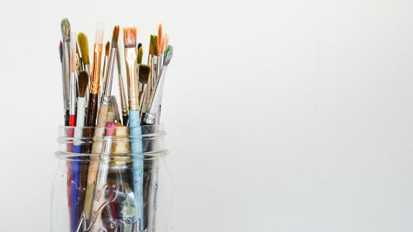 Paintbrushes in a glass jar