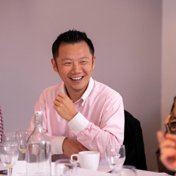 Yasu Kotera is sat at a table smiling