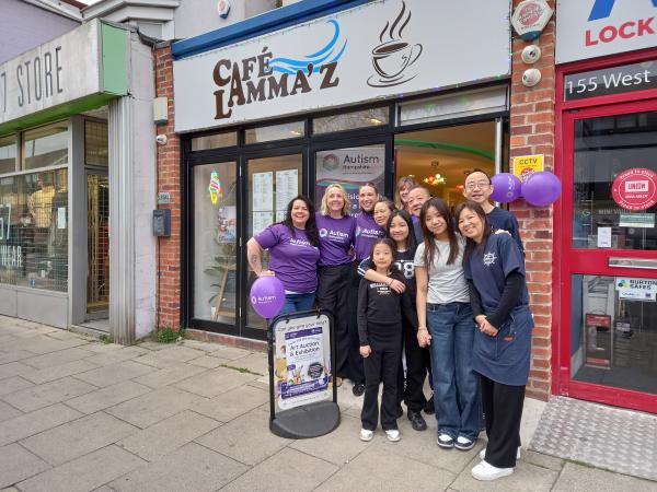 Colleagues from Autism Hampshire and Cafe Lamma'z stand outside the cafe ready for the art exhibition.