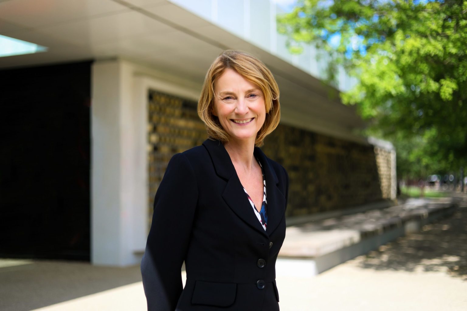 Lyn Garner, new chair of Bristol Temple Quarter stood smiling in front of some trees