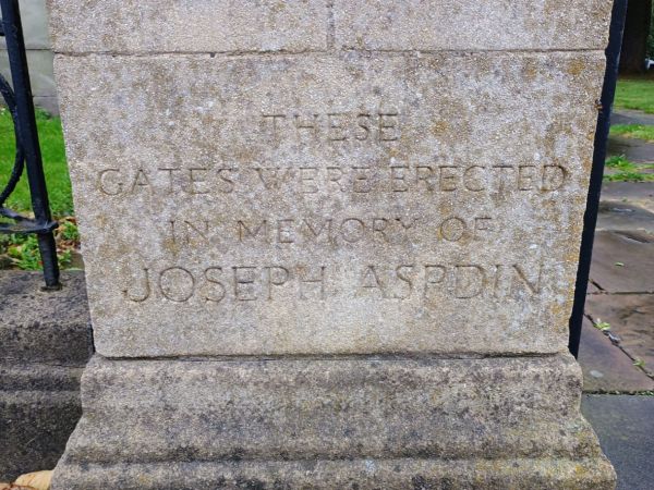 Stone engraving which reads 'These gates were erected in memory of Joseph Aspdin'