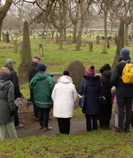 A group of people on a tour in Castleford Cemetery