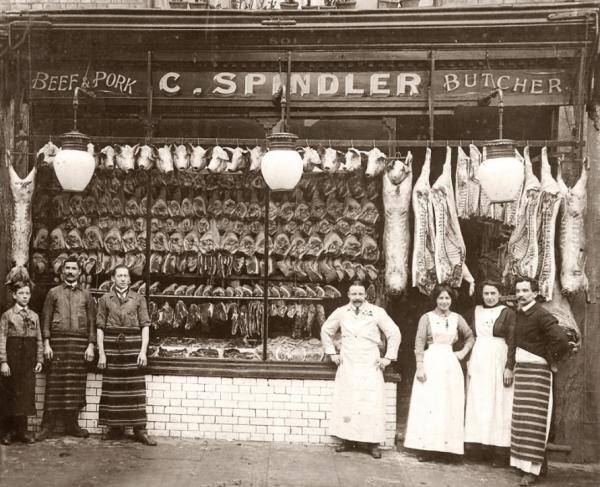 Historic photo of C. Spindler Butchers with staff smiling for a group photo outside the shop