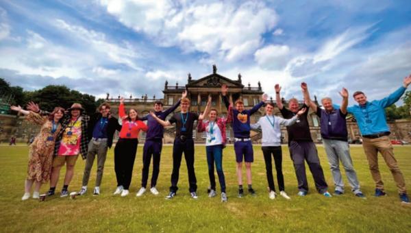 A group of young people standing in front of Wentworth Woodhouse