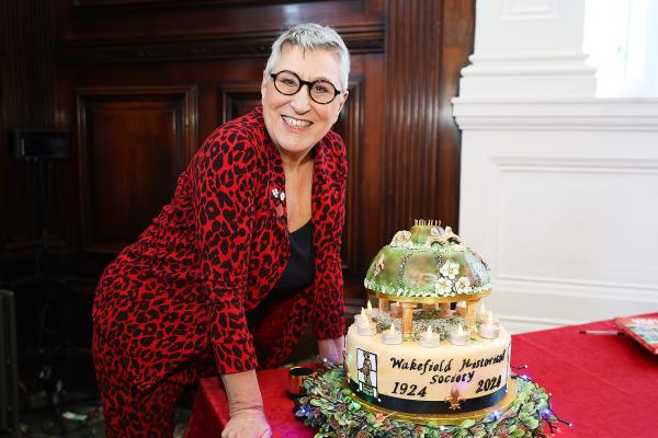 Celebrity baker Karen Wright stood next to a cake made for the Wakefield Historical Society 100th anniversary celebrations