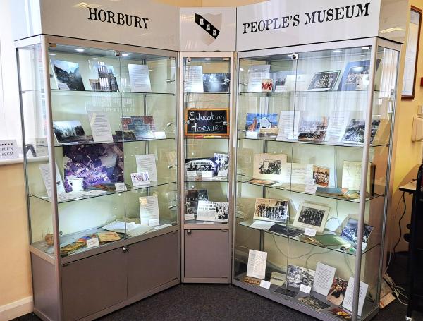 Two tall display cases with historic objects and ephemera on display