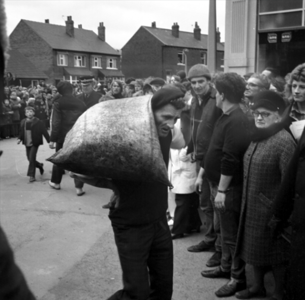 A competitor in the World Coal Carrying Championships in Gawthorpe. Black and white photo.