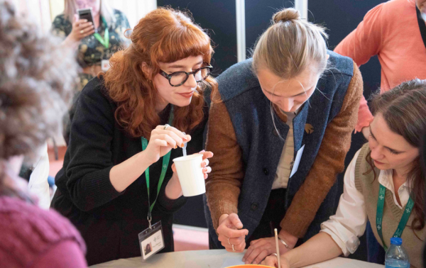 A group of people at a conference around a table