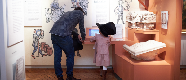 An adult and child looking at a museum display