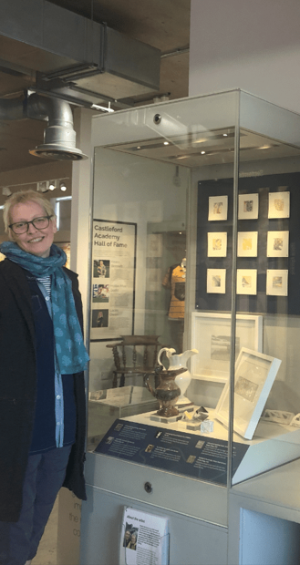 A person standing next to a display case
