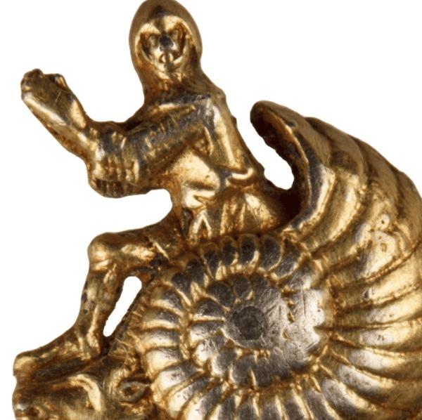 Historic object, a golden statuette of a man sitting on a snail