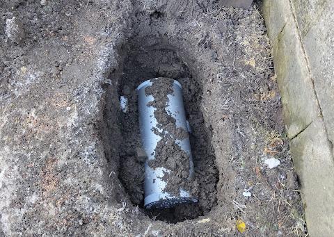 A time capsule partially buried in the ground